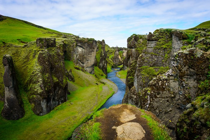 Verdant River Gorge Surrounded by Mossy Cliffs