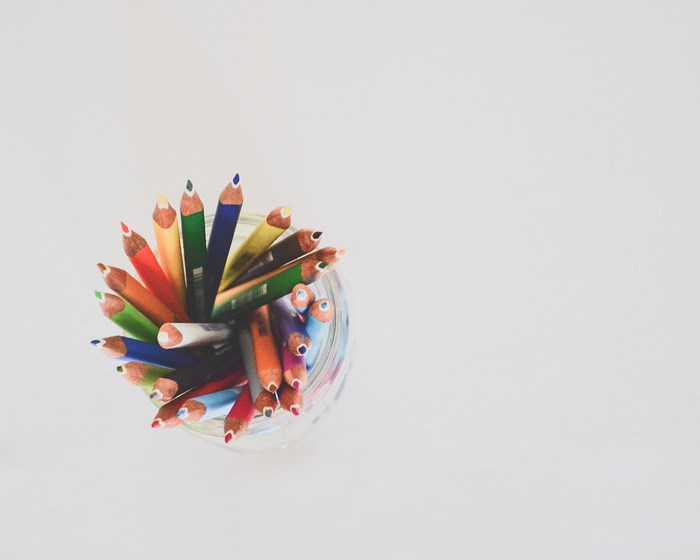 Overhead view of colorful coloring pencils in a jar