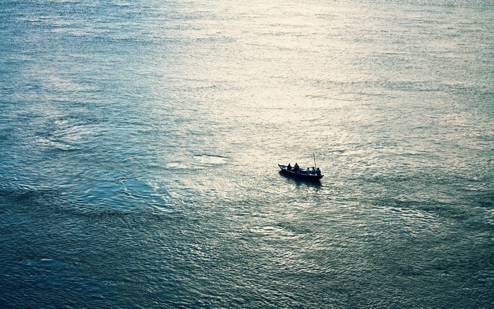 Boat with fishermen on a wide body of water