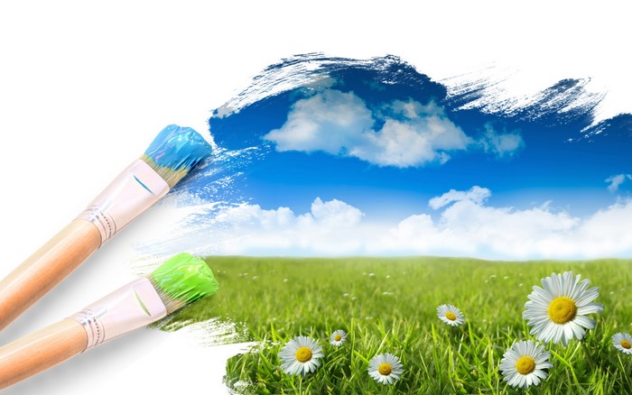 Paintbrushes painting a landscape with sky and grass