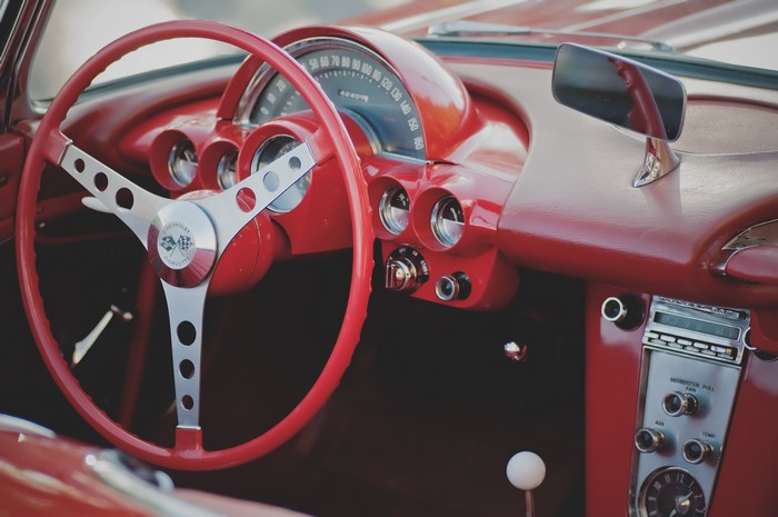 Vintage red Chevrolet Corvette dashboard and steering wheel