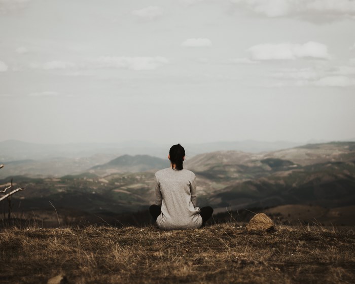 Woman sitting on a hill overlooking a valley in Serbia