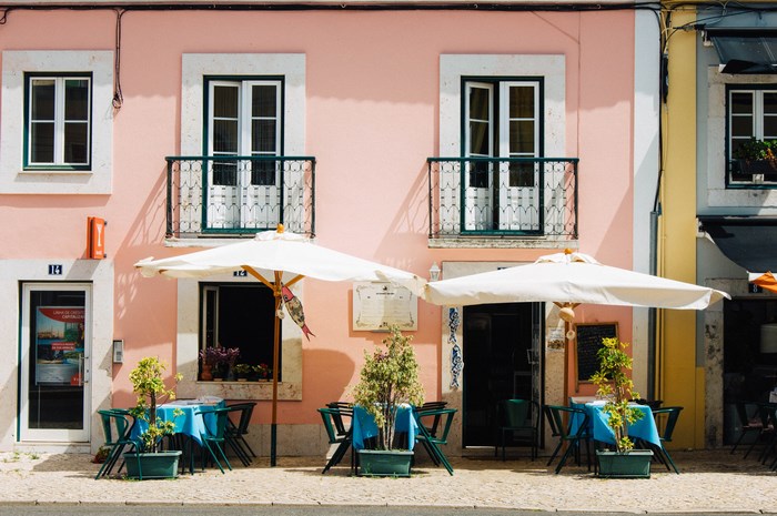 Pink building with outdoor cafe seating in Lisbon