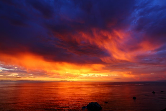 Vibrant Fiery Sunset Over Calm Ocean