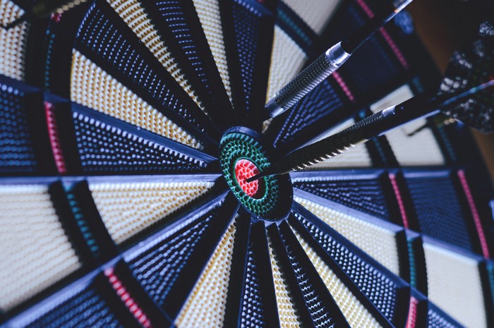 Darts embedded in a dartboard