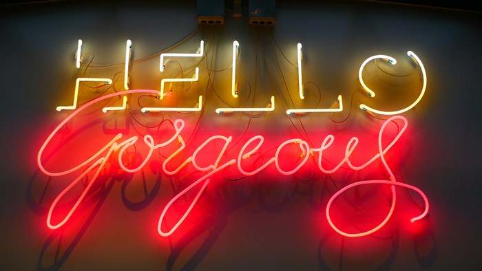Neon sign with "Hello Gorgeous" text