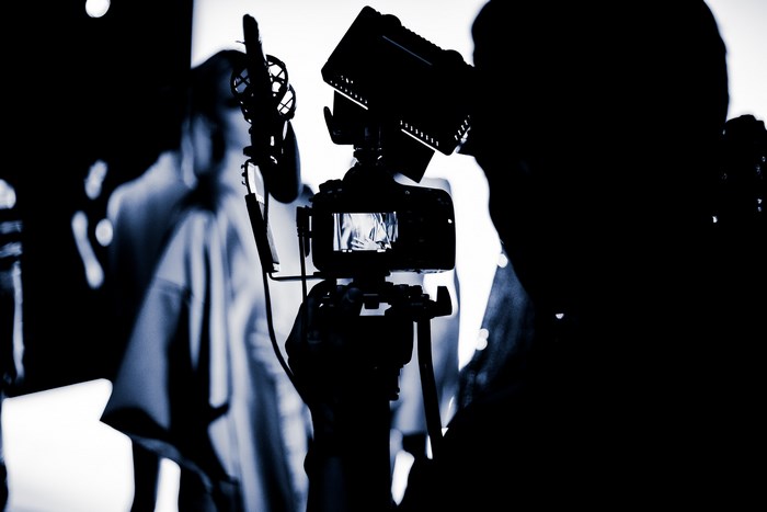 Silhouette of a photographer filming a fashion show