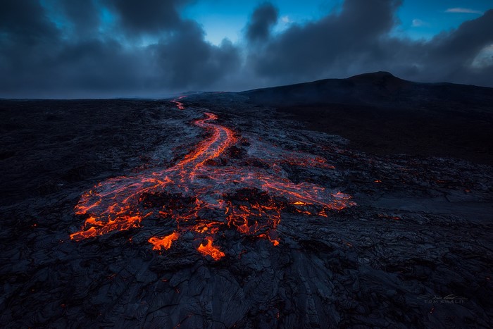 Glowing Lava Flow on Hawaiian Volcanic Island at Dusk