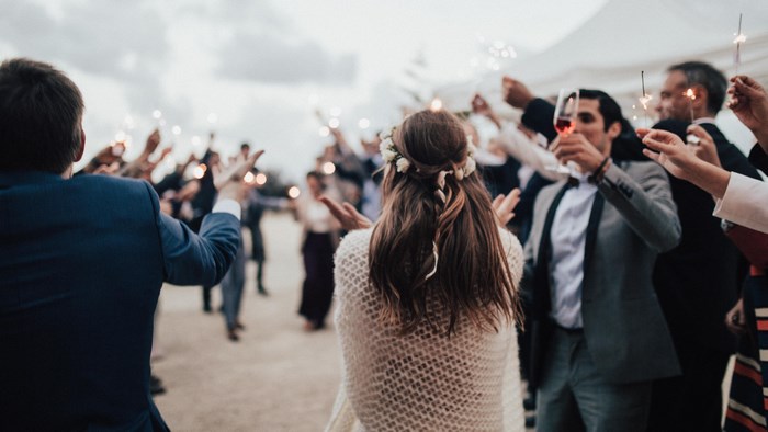 Wedding guests holding sparklers at a party
