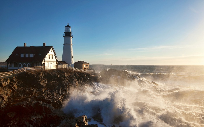 Portland Head Light Lighthouse on a rocky coast with crashing waves