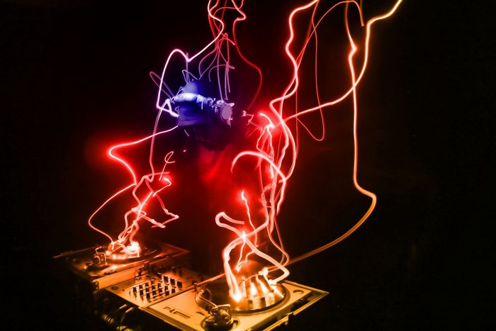 DJ with turntables and light streaks