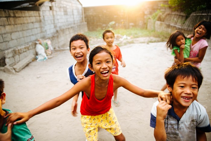Children playing outdoors in the Philippines at sunset
