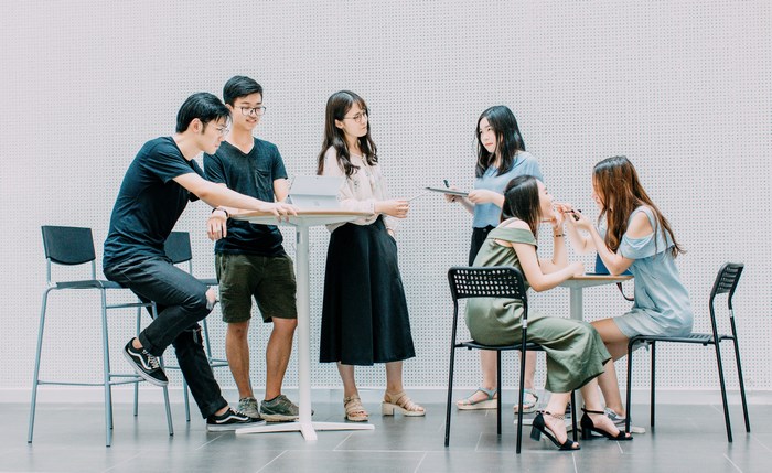 Group of students having a meeting around a table