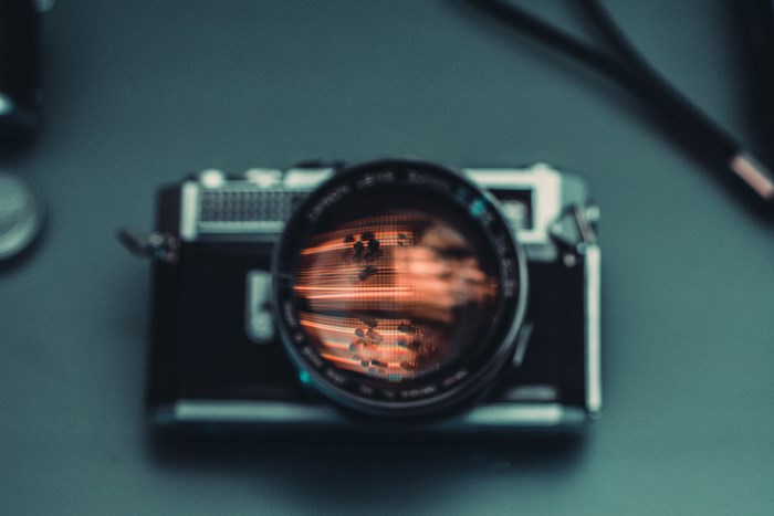 Vintage film camera with reflection in lens