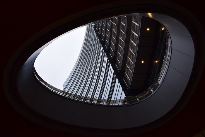 Curved skyscraper viewed through an elliptical opening