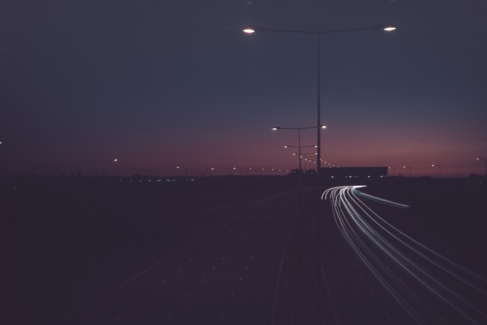 Long exposure of a highway at dusk with light trails