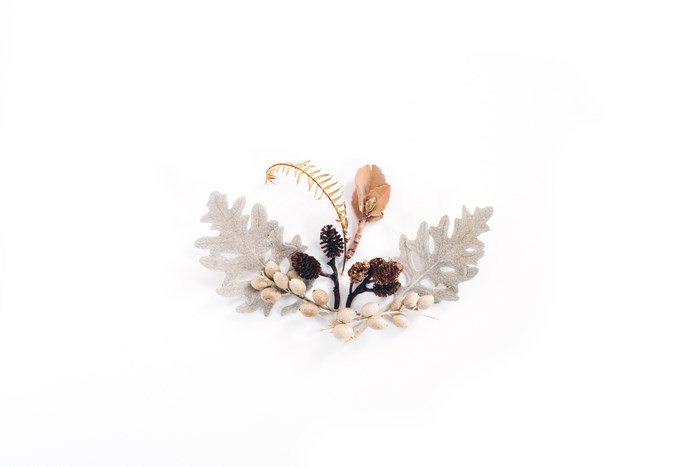 Minimalist arrangement of dried leaves and pinecones