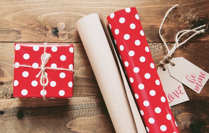Red polka dot gift box with wrapping paper and tags
