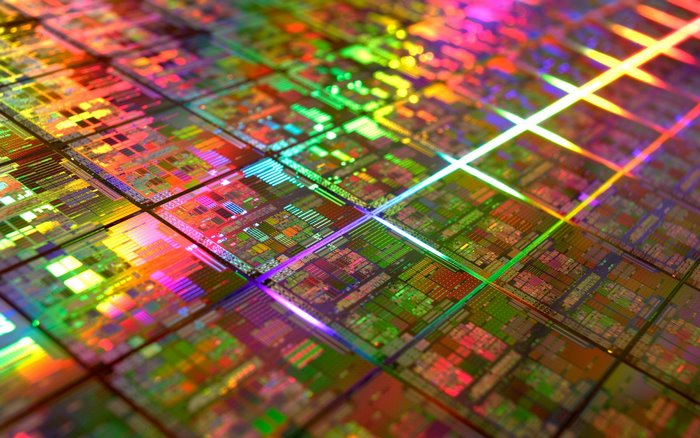 Close-up of a silicon wafer with colorful circuits