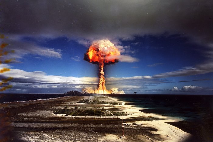 Atomic bomb explosion over a tropical island