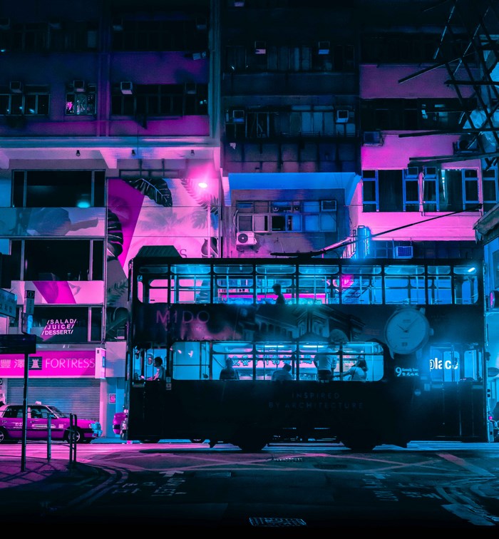 Hong Kong double-decker tram at night with neon lights