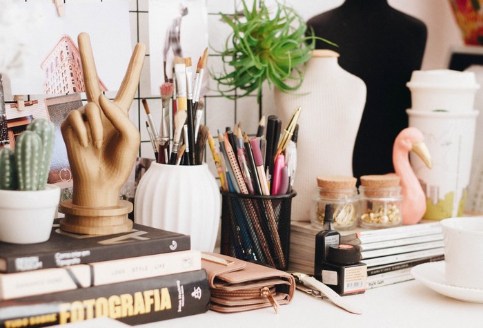 Desk with art supplies, books, and decorations