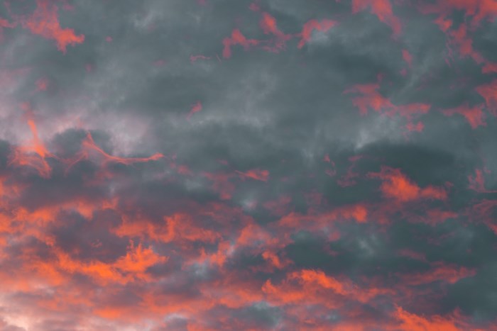 Dark clouds with orange glow at sunset