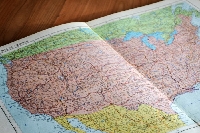 Open map of the United States on a wooden table