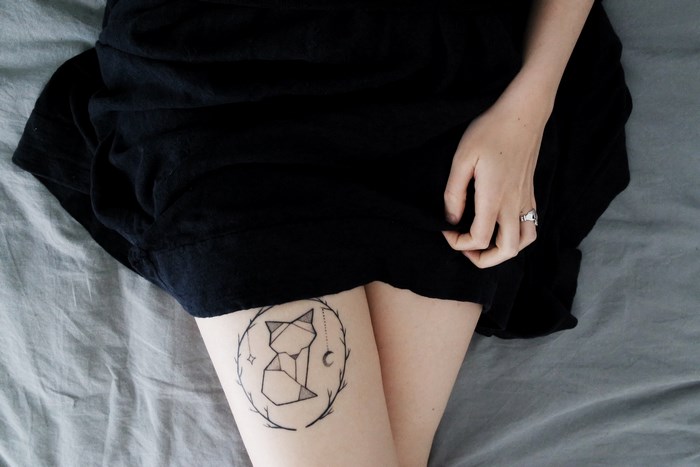 Woman with a fox tattoo on her leg