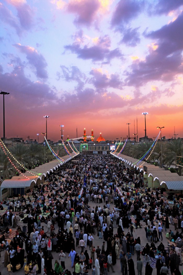 Crowd Gathering at Karbala Shrine at Dusk