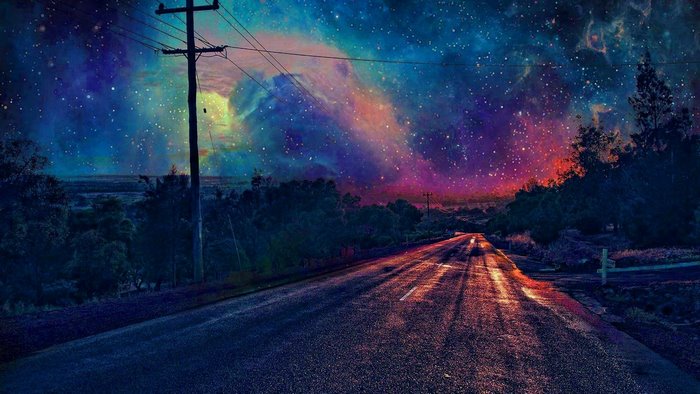 Road under a colorful nebula and starry night sky