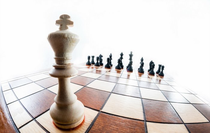 White King and Black Chess Pieces on Chessboard