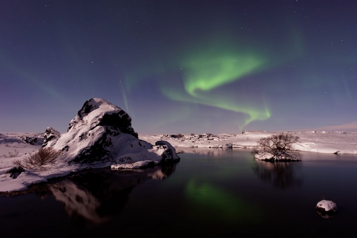 Aurora Borealis over a snowy landscape in Iceland