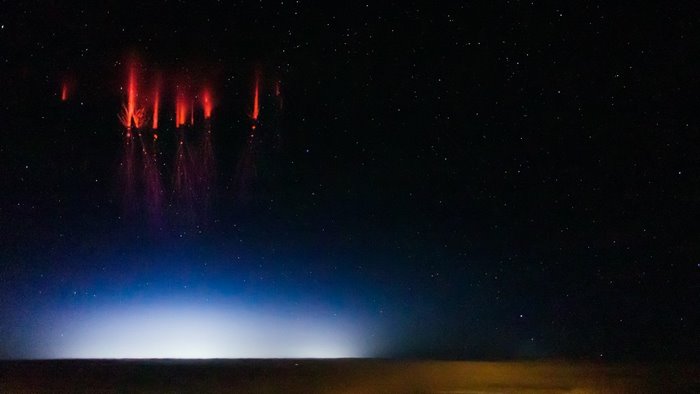 Red Sprites Above a City at Night