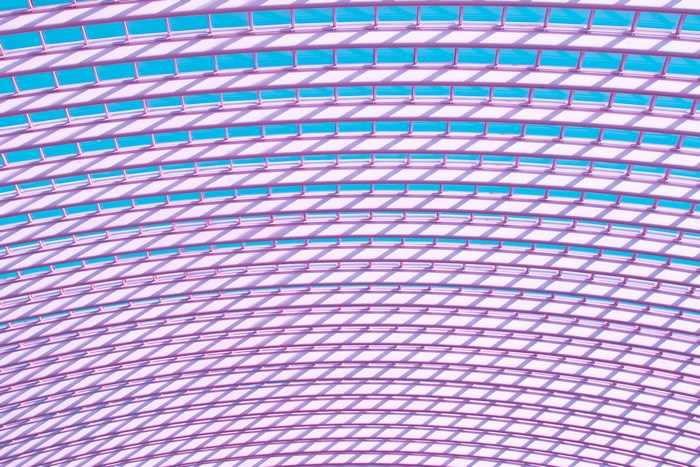 Abstract pattern of purple lines and blue sky