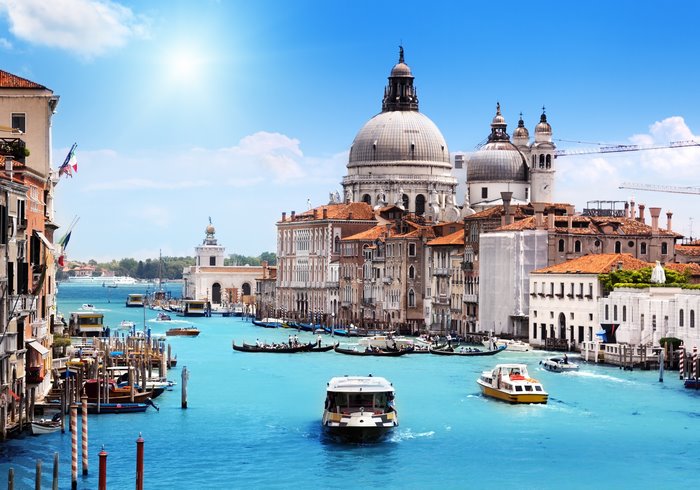 Venice canal with boats and Basilica di Santa Maria della Salute