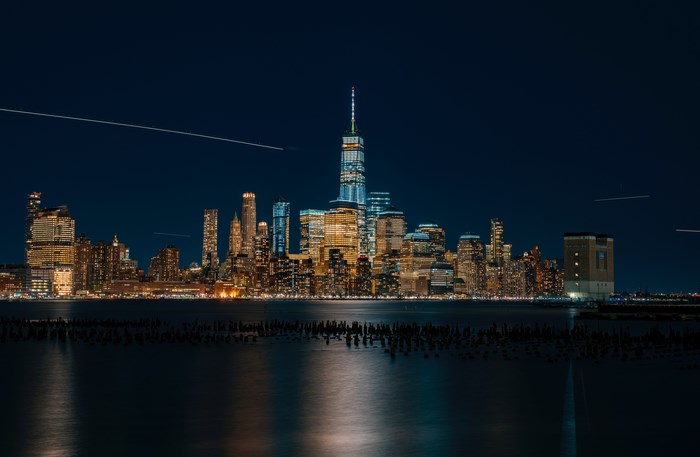 New York City skyline at night with reflections