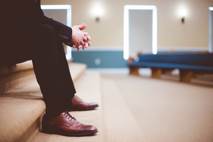 Man in Suit Sitting on Steps