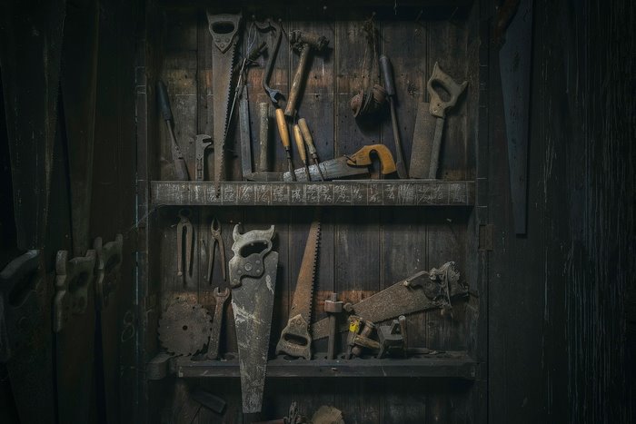 Collection of vintage woodworking tools on a wooden shelf