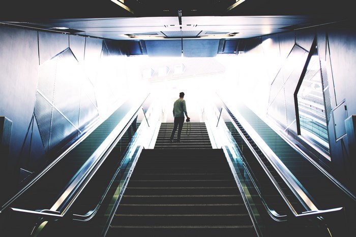 Man on stairs with escalators in Cologne