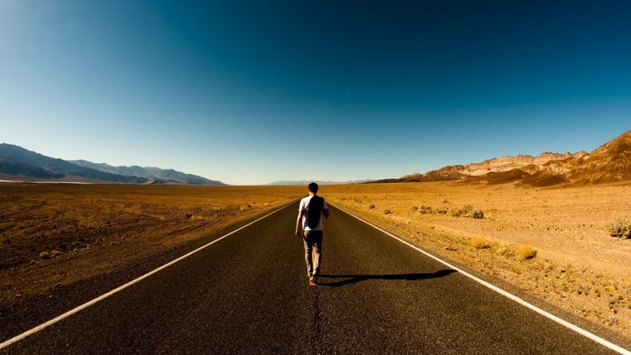 Man walking on a desert road