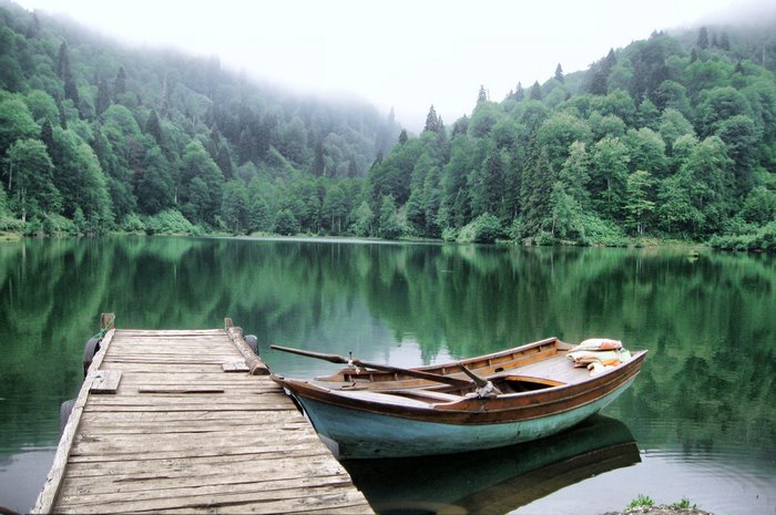 Boat docked on a misty lake in Artvin, Turkey