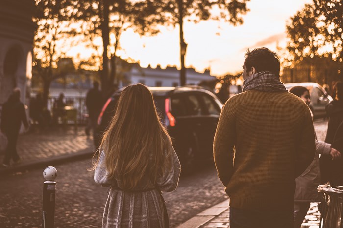 Couple walking on a street in Paris at dusk