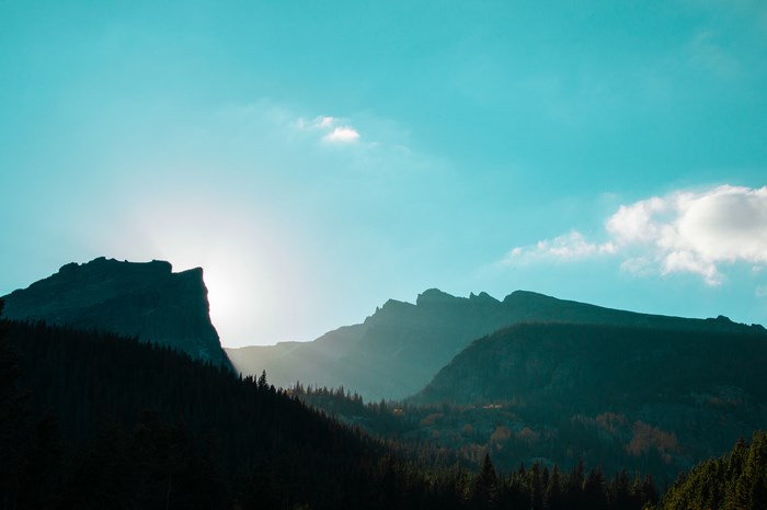 Sunlight behind mountain range in Colorado National Park