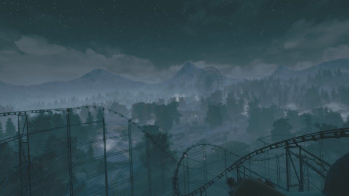 Roller coaster and Ferris wheel in a foggy park at night