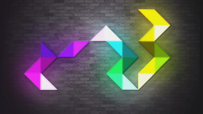 Colorful abstract neon triangles on brick wall