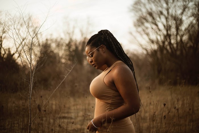 Strong African American Woman with Natural Hair in Forest