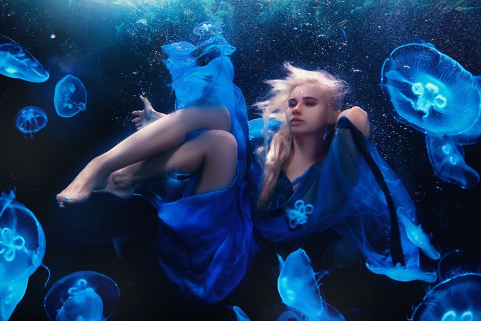 Underwater Woman Surrounded by Glowing Jellyfish