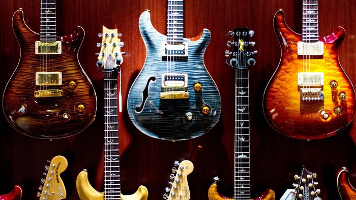 Collection of electric guitars on a wall