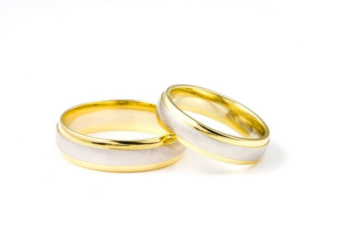 Two gold and white wedding rings